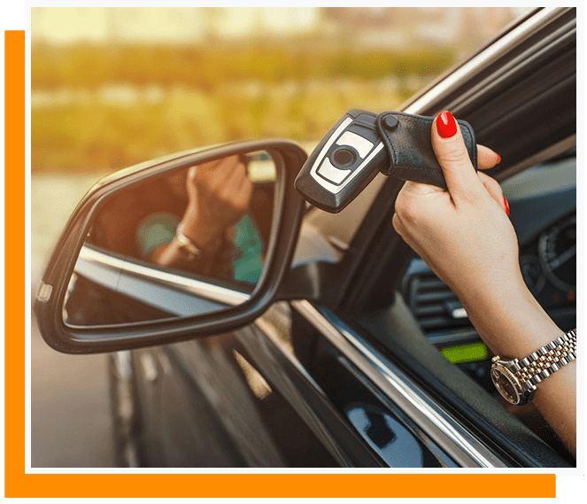 A woman is holding the remote control of her car.