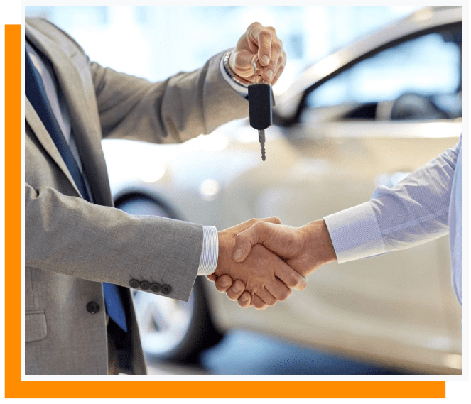 Two men shaking hands over a car with keys in hand.