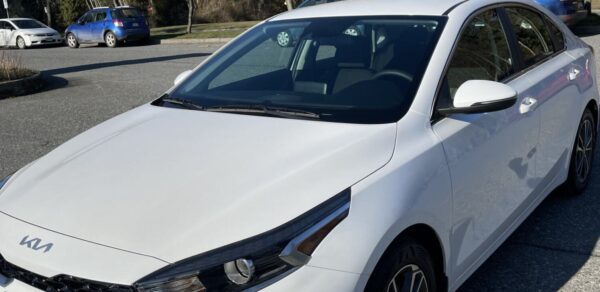 A white car parked on the side of a road.