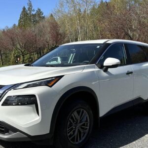 A white car parked on the side of a road.