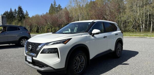 A white car parked on the side of a road.